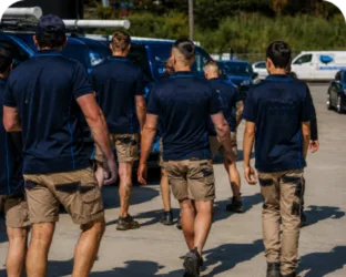 Plumbers walking to their service vans on a Rose Bay job